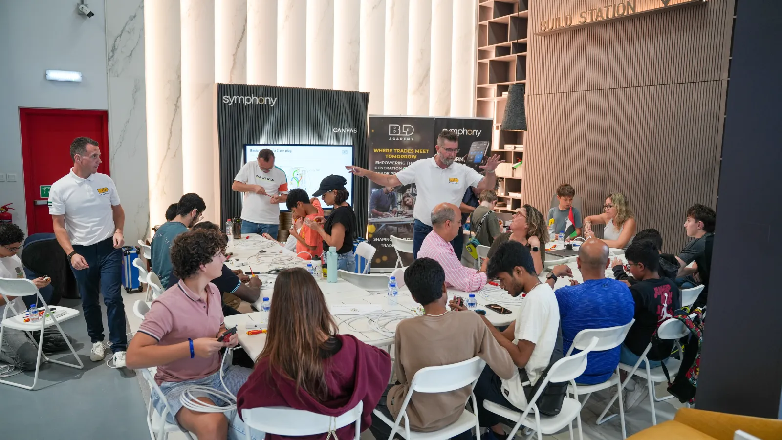 Adults at a BLD Academy DIY electrical workshop in Dubai