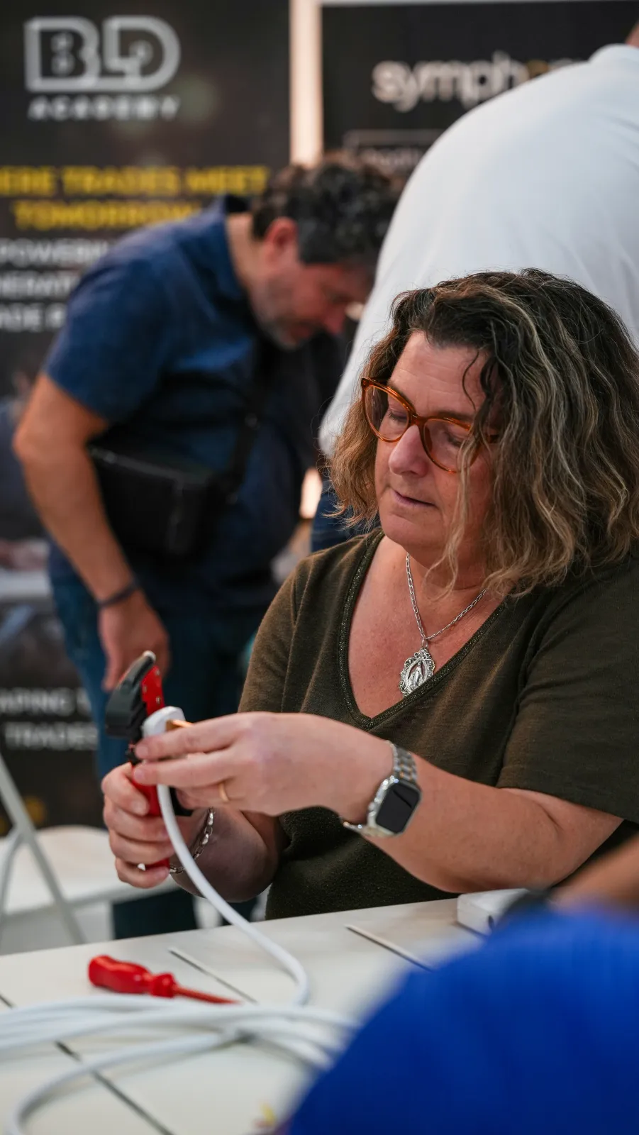 An adult learner using a wire stripper at a BLD Academy DIY workshop in Dubai